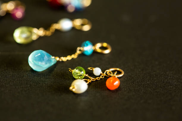 istock lemon quartz, ruby, pearl,labradorite,apatite, green chalcedony, blue topaz necklace charm isolated on black background. 968913628