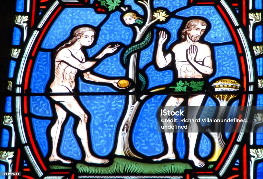 Stained glass window depicting Adam and Eve Adam - Biblical Figure Stock Photo
