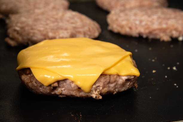 istock Pork patty being grilled with melted cheese on top 968916926