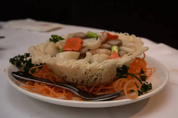 Photo of Seafood stir-fry in birds nest a popular dish in a Chinese restaurant
