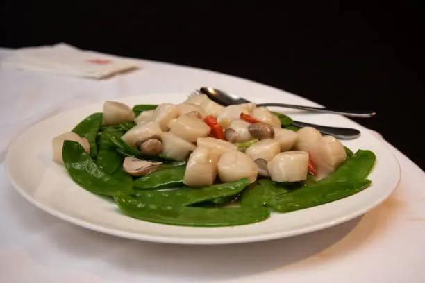 Photo of Stir-fried scallops with snow pea and mushroom, a popular dish in a chinese restaurant