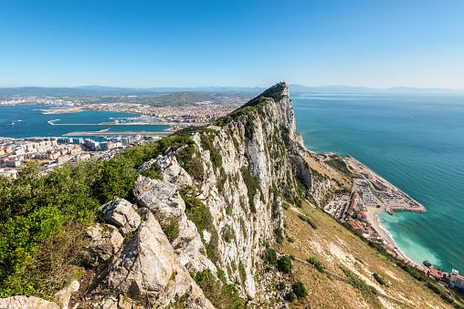 Aerial view of top of Gibraltar Rock, in Upper Rock Natural Reserve: on the left Gibraltar town and bay, Mediterranean Sea on the right, United Kingdom, Europe