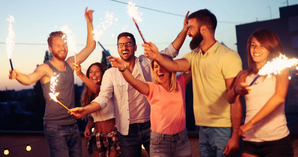 istock Happy friends lighting sparklers and enjoying freedom 968920454