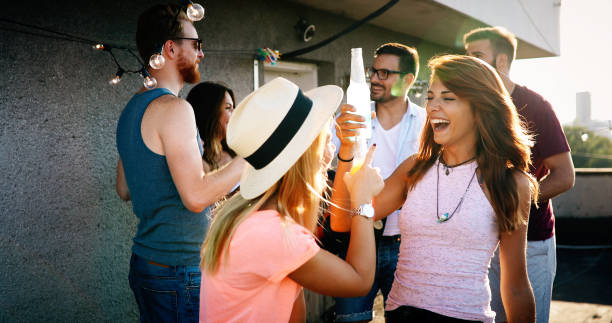 istock Friends having fun at rooftop party. 968920528