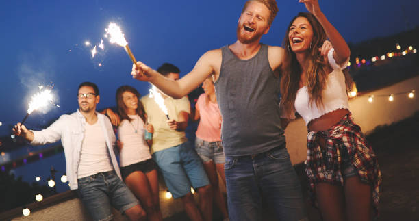 istock Happy friends lighting sparklers and enjoying freedom 968920584
