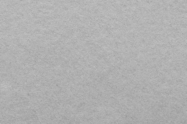 abstract texture of a cardboard or paper material of pale gray color for a background or for wallpaper