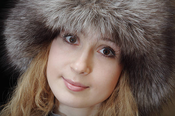 Young woman in fur hat stock photo