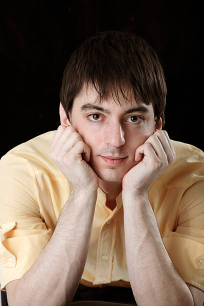 Young man in yellow shirt stock photo