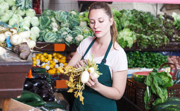 istock seller female is holding white beet 968929018