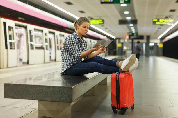 istock Young girl sitting on bench at metro station 968929576