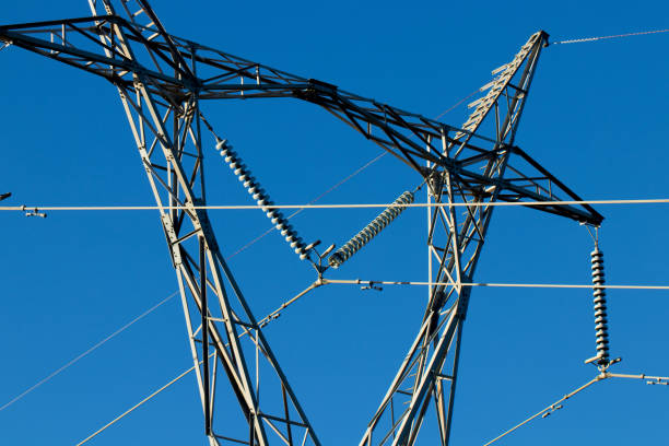istock Industrial electricity tower wires with blue sky 968932076