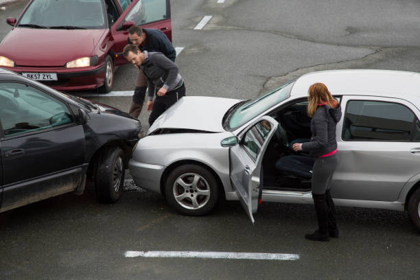 Cars collision Two men looking at cars collision on road, woman standing near car. t shirt caucasian photography color image stock pictures, royalty-free photos & images