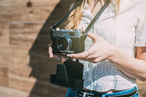 istock Cropped woman with vintage old camera 968935284