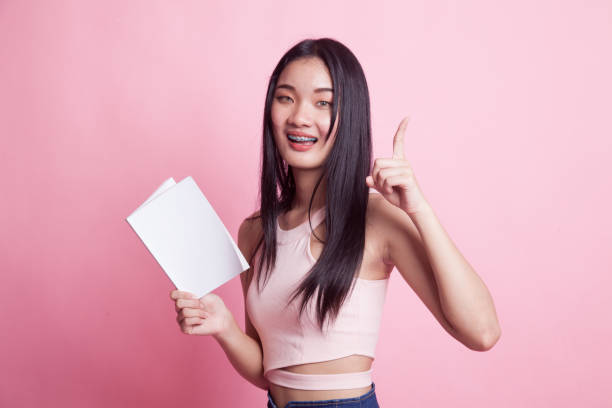 istock Young Asian woman with a book have an idea. 968936350
