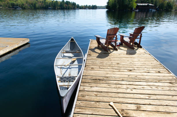 istock Muskoka chairs on a wooden dock 968936440