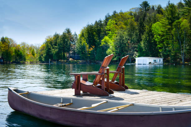 istock Muskoka chairs on a wooden dock 968936460