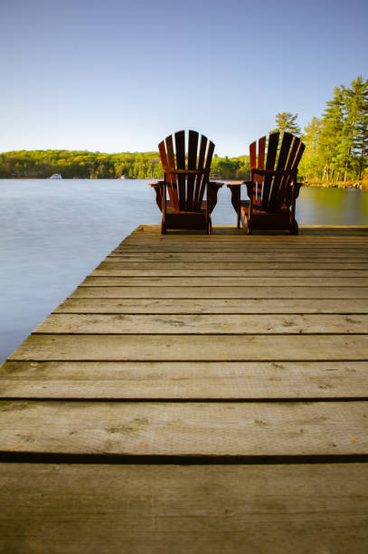 istock Muskoka chairs on a wooden dock 968936472