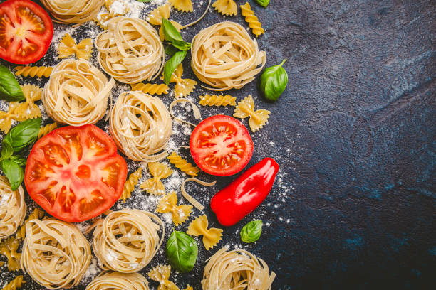 istock Pasta and fresh vegetables scattered in flour 968939794