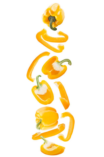 Falling sweet yellow pepper isolated on white background with clipping path as package design element and advertising. stock photo