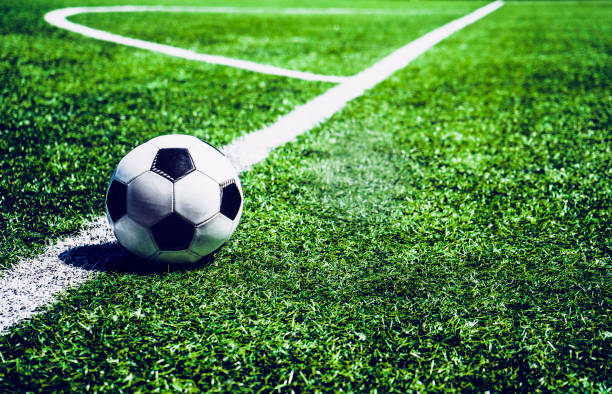 istock Soccer ball on the white line at field 968944702