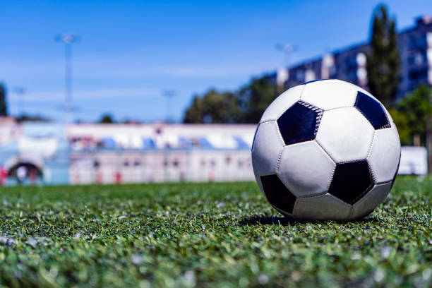 istock Soccer ball on grass in soccer stadium. 968944884