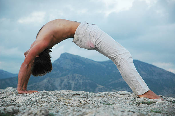 hatha-yoga: pont - yoga men bridge bending over backwards photos et images de collection