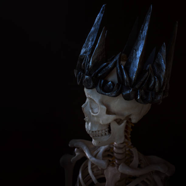 istock The skull in crown. Grim necromancer in Gothic crown. Black background, Halloween concept 968947282