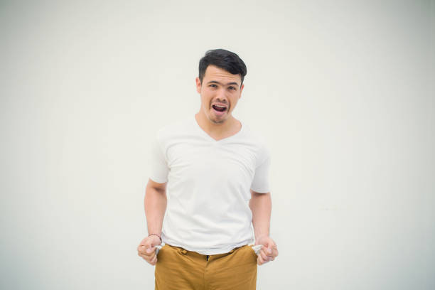 istock Man with no money poor gesture standing showing his empty pocket on the white background 968949364
