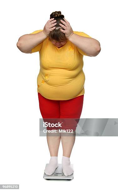 Overweight Woman Standing On A Scale Stock Photo - Download Image Now - Adult, Clothing, Color Image