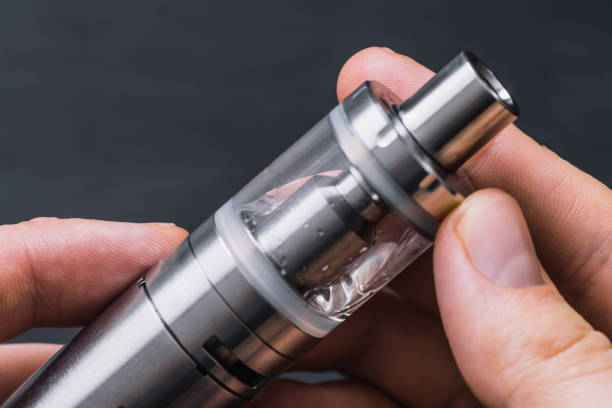 istock vaping mechanical mod. Young vaper man with beard Guy smokes 968952274