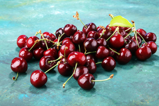istock Cherry. Red fresh bunch of cherries on the table 968956848