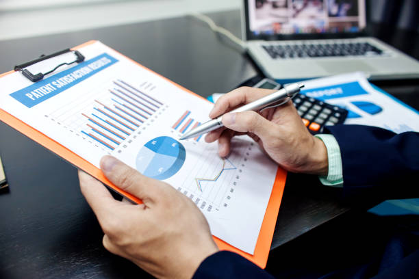 istock Business man at working with financial reports and laptop computer in the office 968959602