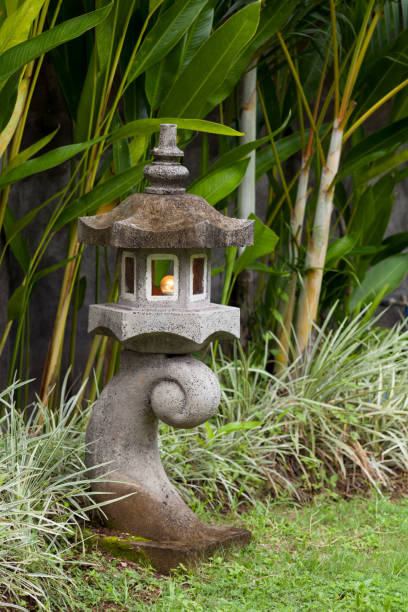 istock Stone lantern in garden with green plants 968961252