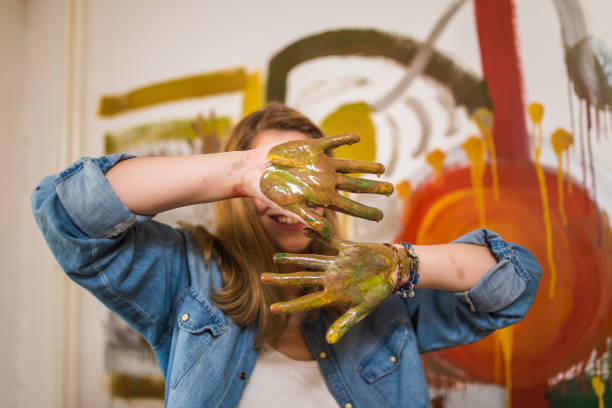 istock Girl covering her face with painted hands 968965172