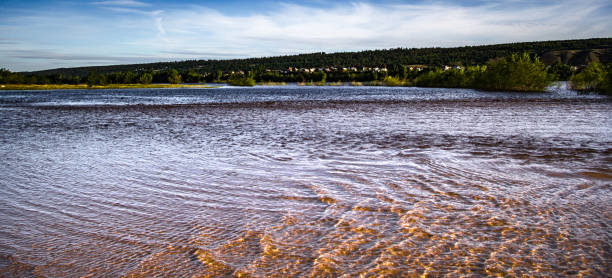 istock golden sand in the river with mountains and white clouds background 968965822