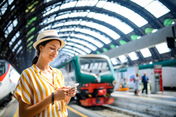 Woman text messaging at train station.