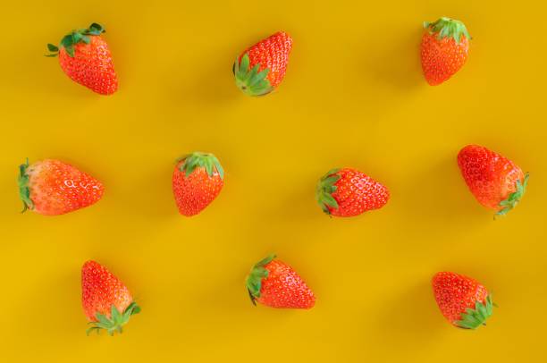 istock Strawberry - berries fruit on yellow background. 968973052
