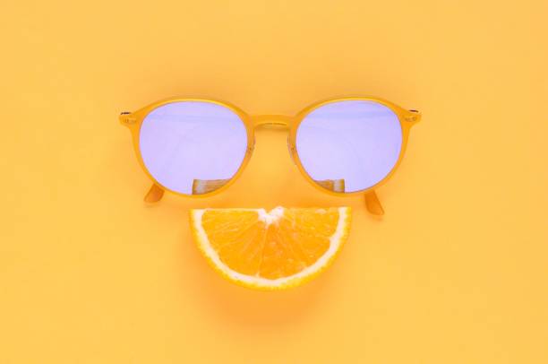 istock Slice orange fruit and yellow sunglasses on yellow background. 968973336