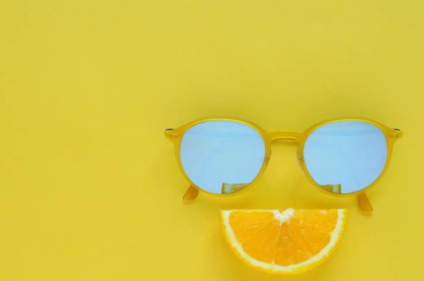 istock Slice orange fruit and yellow sunglasses on yellow background. 968973338