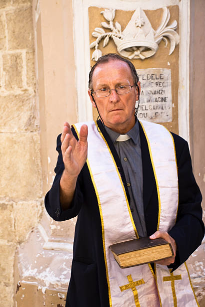 istock Priest holding Bible gives a blessing 96897704