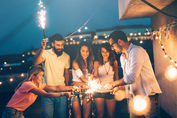 istock Group of happy friends celebrating at rooftop 968977110