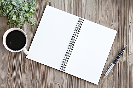 Still life, business, office supplies, planning or office life concept : Top view or flat lay of open notebook with blank pages, coffee on office desk table with copy space ready for adding or mock up