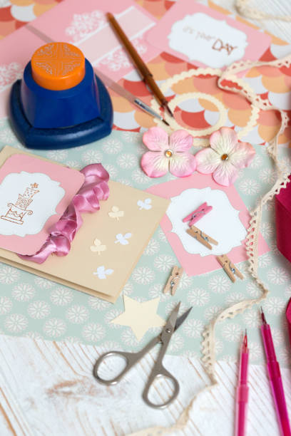 istock scrapbook background. process of creating a postcard - Card and tools with decoration 968980488