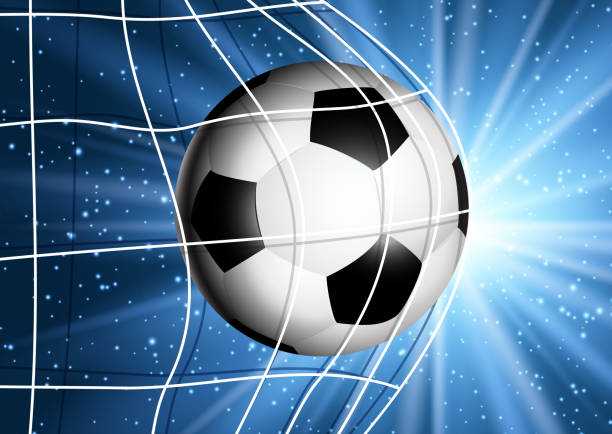 istock Football or soccer ball flying into the goal 968984164