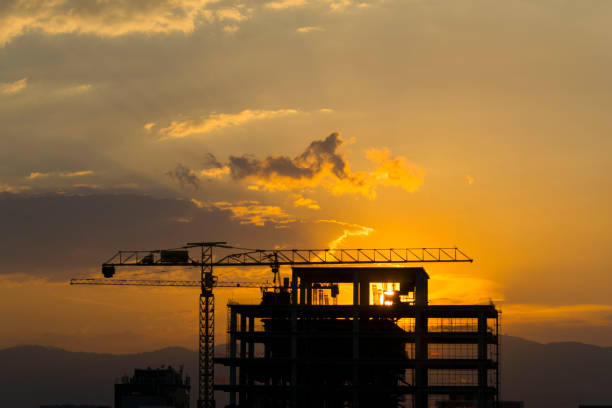 Construction of building between trees Guatemala City, silhouette at sunset.