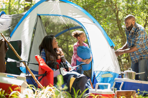 istock Family on summer or autumn vacation camping in forest. 968990364