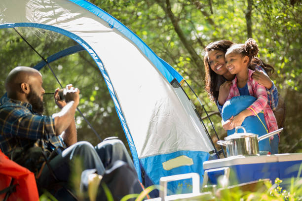istock Family on summer or autumn vacation camping in forest. 968990530