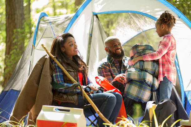istock Family on summer or autumn vacation camping in forest. 968990664