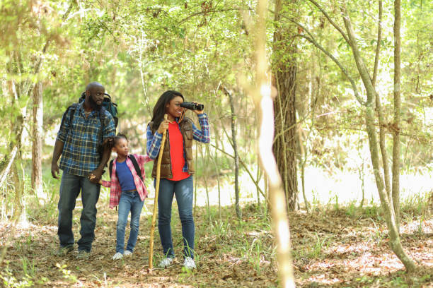 istock Family on summer or autumn vacation camping in forest. 968990754