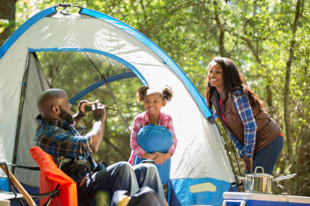 istock Family on summer or autumn vacation camping in forest. 968991086